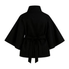Black women's sculptural wool-blend cape jacket with belt from Les Odettes, shown from the front view.