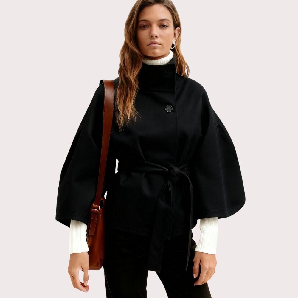 Black women's wool blend belted sculptural cape jacket with front view, featuring a modern, stylish outerwear design by Les Odettes.