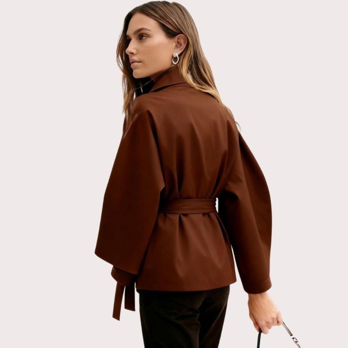 Side view of women's brown Wool Blend Sculptural Cape Jacket with belt by Les Odettes, showcasing elegant outerwear design.
