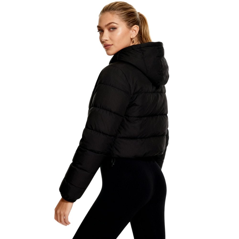 Side view of women’s black lightweight insulated nylon cropped puffer jacket by Les Odettes, showcasing its puffy style and quilted design.