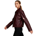 Women’s burgundy vegan leather jacket by Les Odettes, featuring a stylish bomber design and side view detail.
