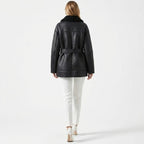 Back view of Les Odettes women's belted faux shearling aviator jacket featuring a cozy, textured shearling exterior and stylish design.