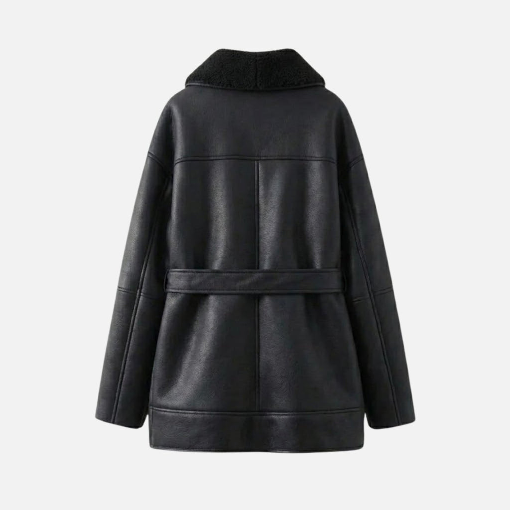 Black women's shearling jacket by Les Odettes, shown flat with back view, featuring cozy shearling trim and stylish design.