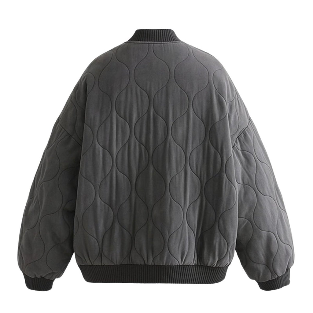 Women's quilted cotton jacket by Les Odettes, oversized charcoal bomber style with lightweight thermal insulation, shown from the back.