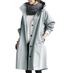 Light blue women's waterproof raincoat with hood from Les Odettes, lightweight and designed for rainy weather.