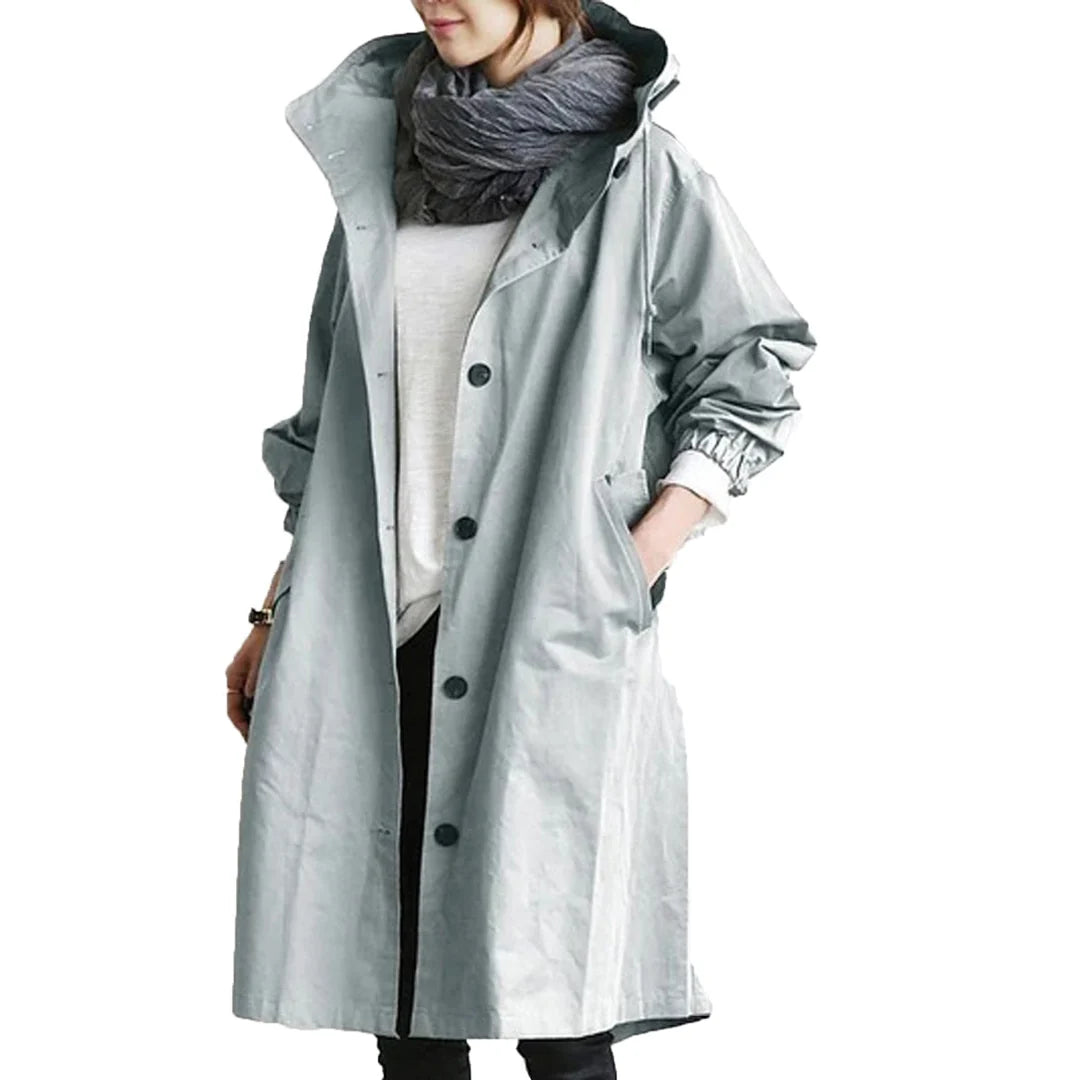 Light blue women's waterproof raincoat with hood from Les Odettes, lightweight and designed for rainy weather.