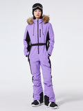 Les Odettes women's Arctic Queen slim fit windproof one-piece ski suit, shown in black with hood and zipper details.
