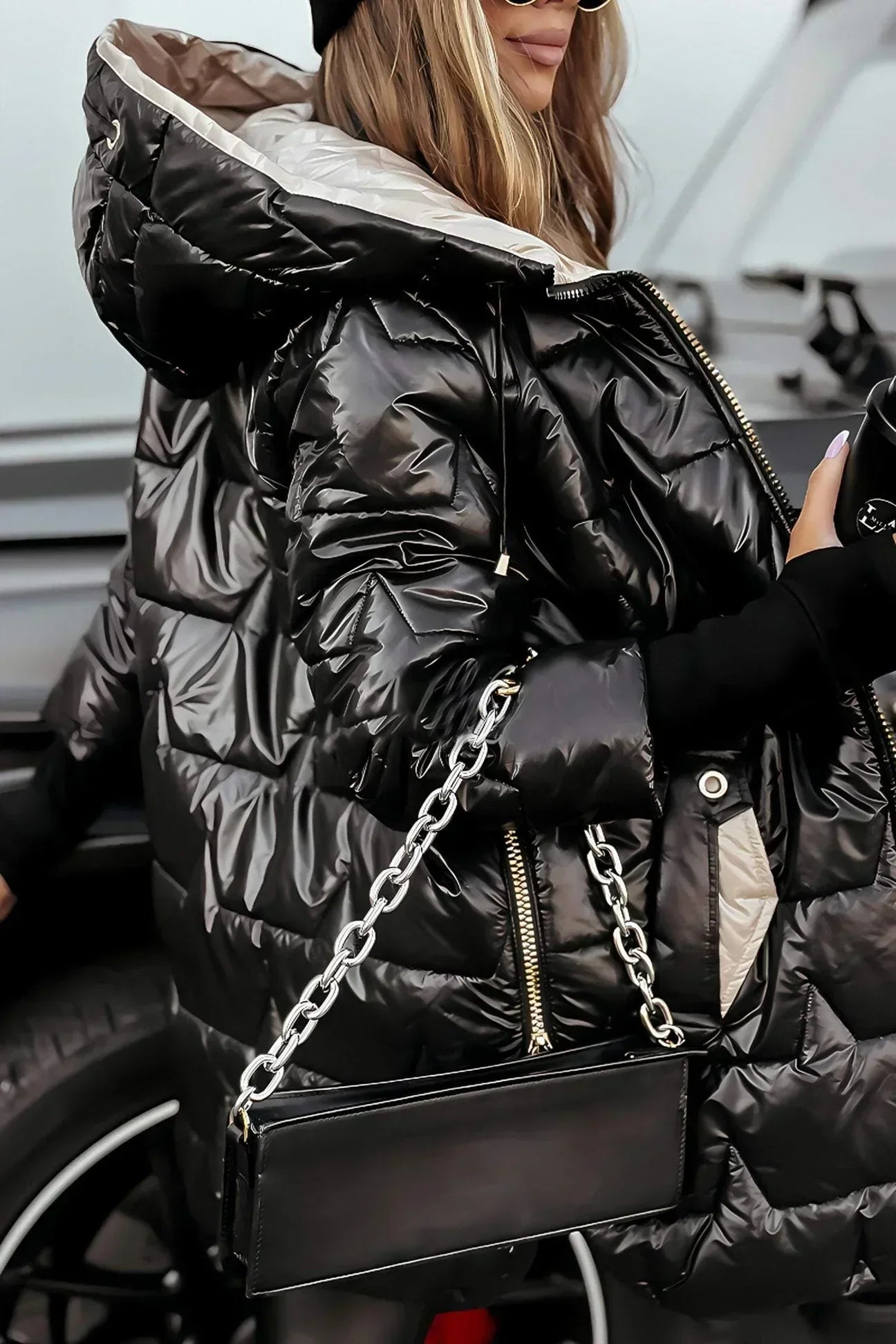 Black Raven™ winter coat by Les Odettes featuring a stylish, insulated design with a high collar and sleek silhouette.