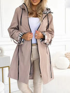 Les Odettes Becca waterproof and windproof zip coat in black, featuring a sleek design and secure front zipper.