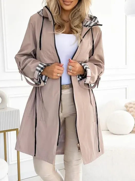 Les Odettes Becca waterproof and windproof zip coat in black, featuring a sleek design and secure front zipper.
