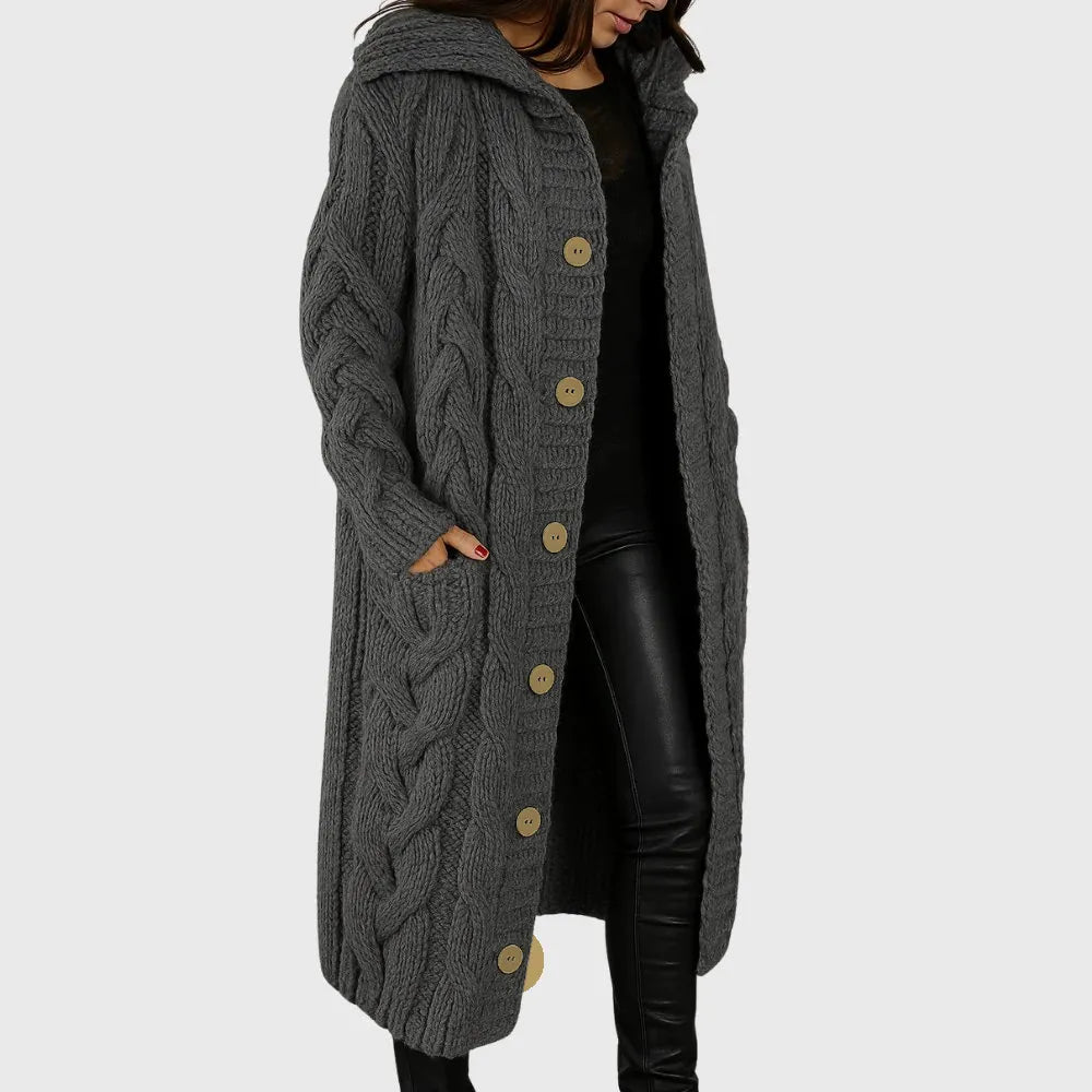 Les Odettes Cadence™ Elegant Cosy Coat displayed on a hanger, featuring a soft fabric and tailored design in neutral tones.