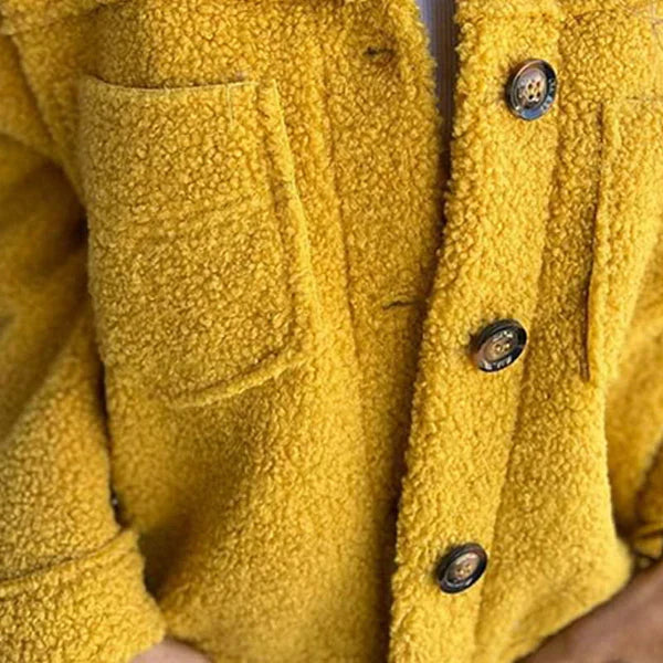 Les Odettes Marleau™ jacket with lapel collar, stylish coat featuring a tailored fit and classic design.