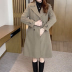 Les Odettes Stella™ sophisticated trench coat in beige with classic double-breasted design and belt, displayed on a hanger.